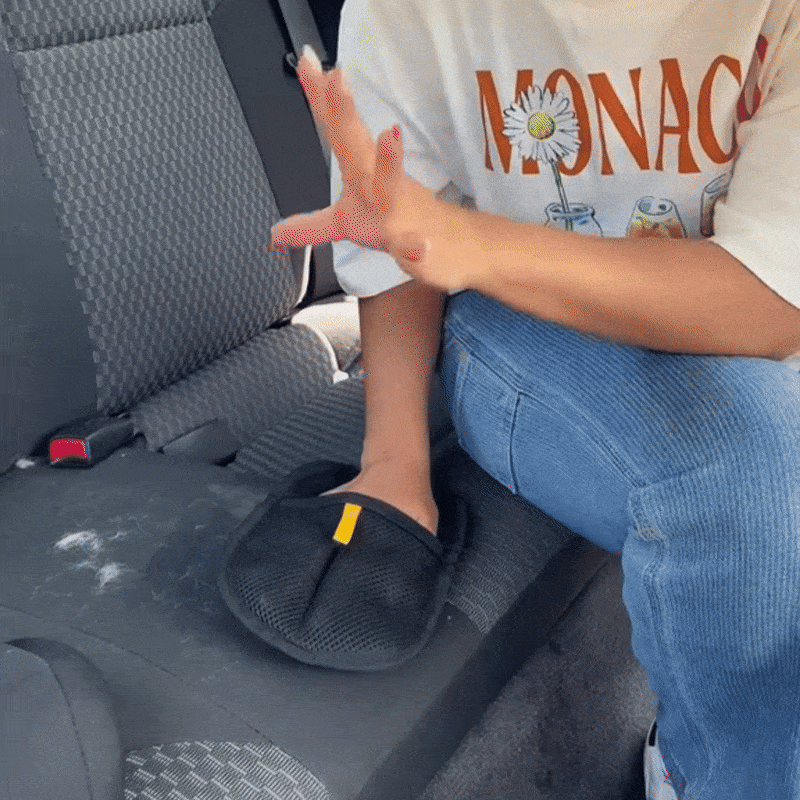 PawTidy™ glove cleaning pet fur from a car seat and interior – quick and eco-friendly cleaning solution.